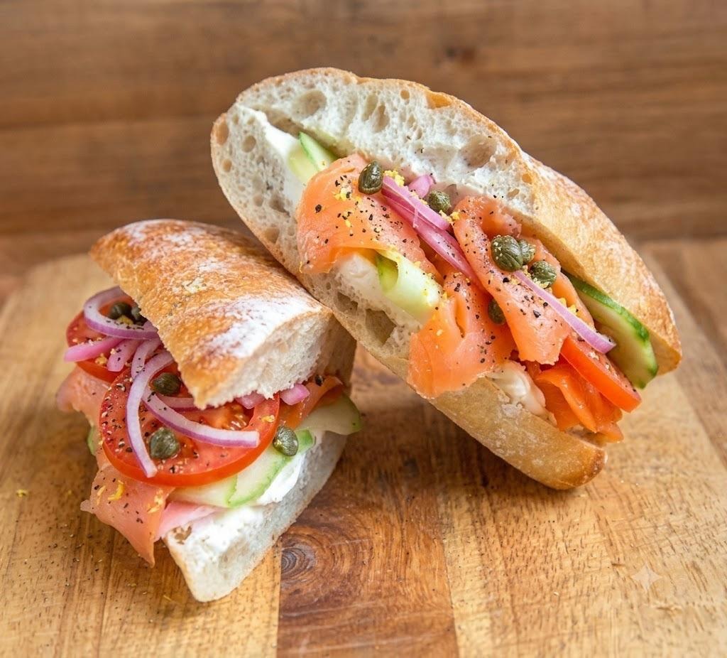 Peaberry lox sandwich with smoked salmon, cream cheese, cucumber, tomato, red onion, and capers