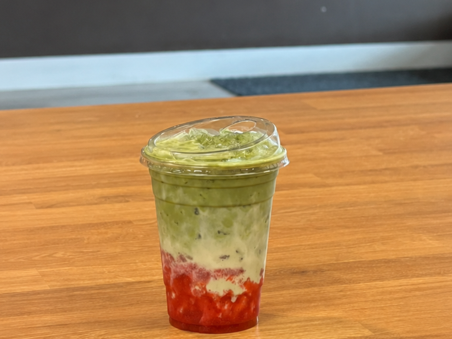 Iced Strawberry Matcha layered with house-made strawberry purée