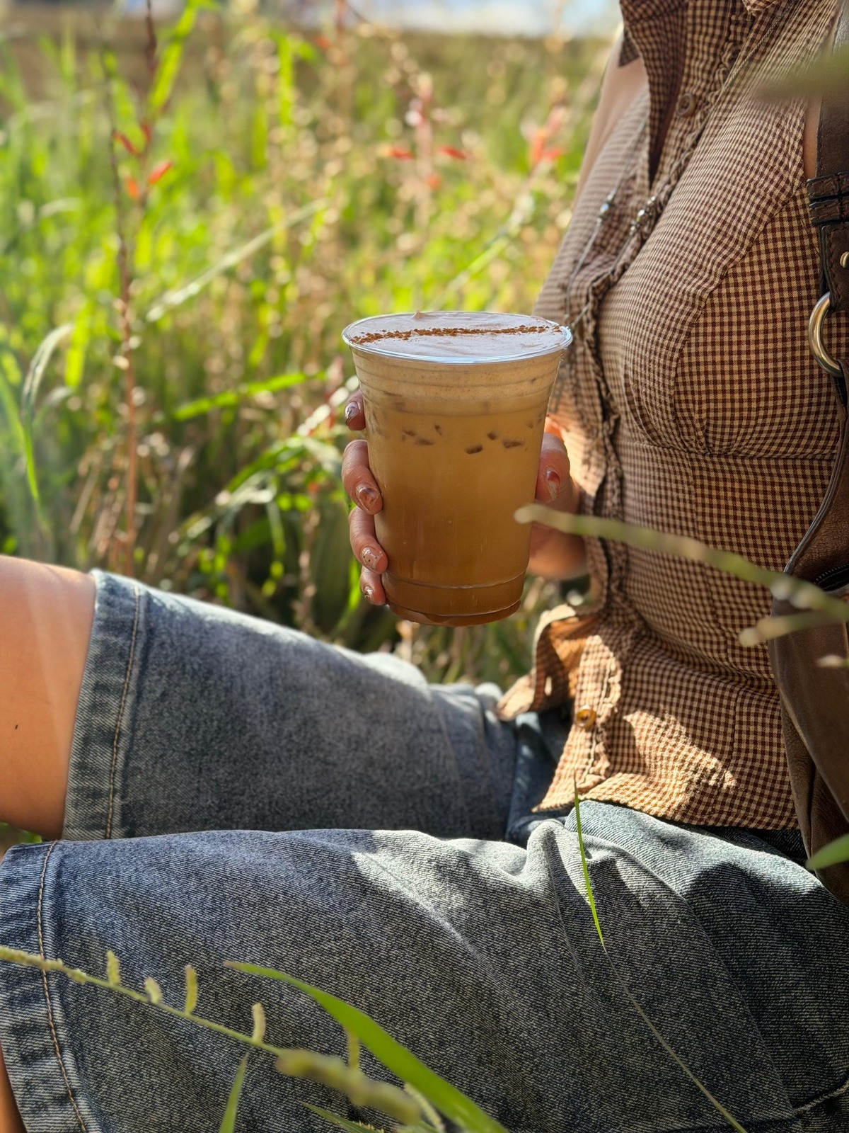 Iced Tiramisu Latte enjoyed outdoors in golden-hour light